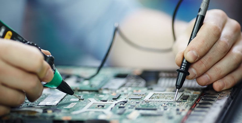 Ingeniero eléctrico del servicio técnico de Kinegun realizando mantenimiento a equipos médicos